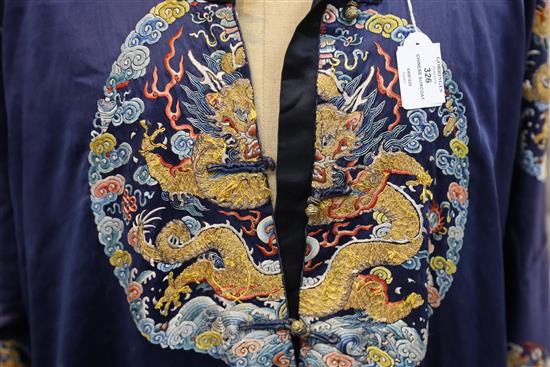 A Chinese noblewomans embroidered silk midnight blue surcoat (longgua), late 19th century, 138cm long, minor alterations to sleeves an